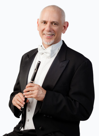 Brian Gordon Wearing white tie and tails holding wood piccolo