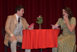 Man and woman sitting at table from the play She Loves Me