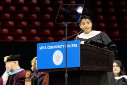 Representative Lorena Austin speaking at lectern at MCC's graduation in 2024