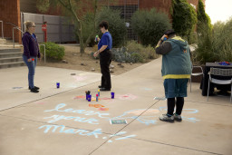 MCC students drawing on the sidewalk