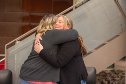 Two women hugging each other