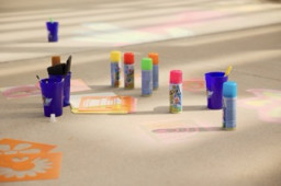 Paint and chalk supplies on the sidewalk