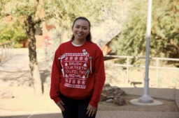 Dental student wearing a red sweater that says "Brush your teeth you filthy animal"