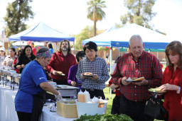 People standing in line getting food at birthday celebration