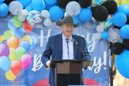 Man in cowboy hat speaking at podium