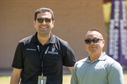 Two men from College Technology Services standing in front of building