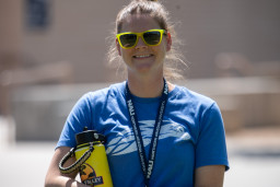 Cara Webb wearing yellow sunglasses holding yellow water bottle