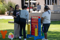 Students playing large size Connect Four game