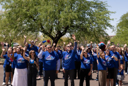 Several people waiving to the sky at the Red Mountain Campus