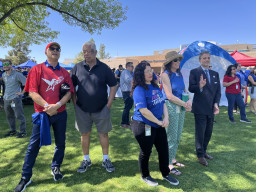 MCC employees and guests standing on grass at the celebration