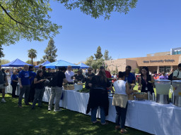 Lots of people standing in line getting food.