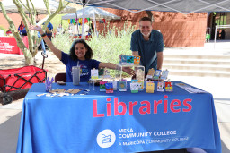 2 people sitting at table with information about MCC libraries