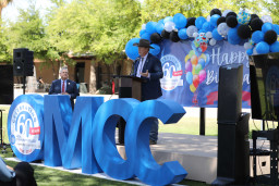 Man in cowboy hat standing at podium speaking to guests