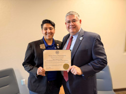 Lorena Austin and Richard Daniel holding commendation