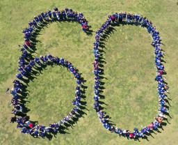 People standing to form the number 60 at the Southern and Dobson Campus