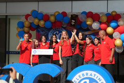 Group photo of Women's Cross Country team holding their 1st place national championship trophy