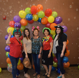 RM Employees under a balloon arch at employee celebration event