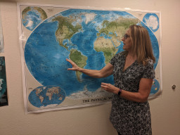 Erinanne Saffell standing in front of a map