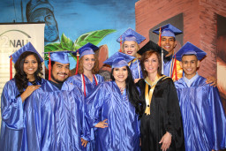 Retiree faculty Tina Rangel (in black gown) poses with students from the dance program