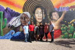Students standing in front of painted wall