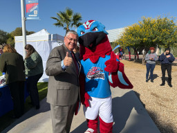 MCC President, Dr. Daniel standing with Thor giving a thumbs up sign.