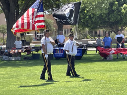 Individuals presenting US and POW MIA flags
