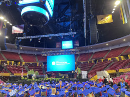 Wide shot of students sitting at MCC's graduation ceremony at ASU's Desert Financial Arena