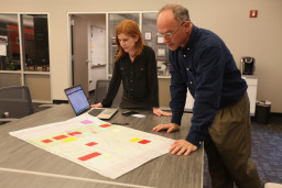 Jennifer Fey and Steve budge looking at a pathway map