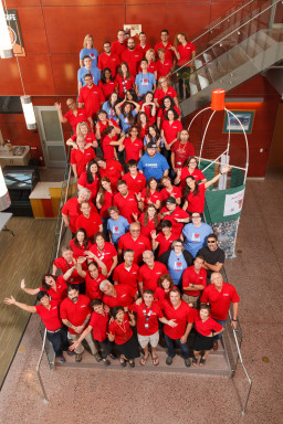 Employees posing on staircase for RM 15th anniversary