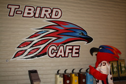 Thor looking at a sign "T-Bird Cafe" in the student cafe