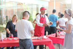 Greg Reents serves up ice cream sundaes for employees.