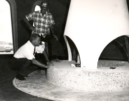 John Riggs inspects the fireplace in the Faculty Lounge in the Kirk Center, 1965