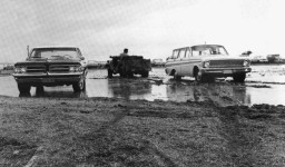 Cars parked in a muddy parking lot, 1967, Southern & Dobson Campus