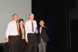 Hall of Fame recipient Robert Jacks is joined on stage by Athletic Director John Mulhern,  Alumni Relations Coordinator Marcy Snitzer, and MCC President Dr. Shouan Pan.