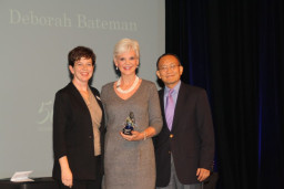 Hall of Fame inductee Deborah Bateman holds her HOF statue between Alumni Relations Coordinator Marcy Snitzer and MCC President Dr. Shouan Pan.