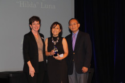 Hilda Luna, center, was inducted into the 2015 MCC Hall of Fame. She is joined on stage by Alumni Relations Coordinator Marcy Snitzer and MCC President Dr. Shouan Pan.