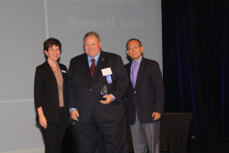 Hall of Fame inductee Terence Azbill is joined onstage by Alumni Relations Coordinator Marcy Snitzer and MCC President Dr. Shouan Pan.