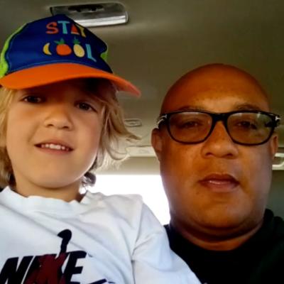 Jason Carter and his son wearing a baseball cap