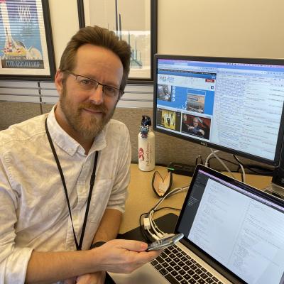 Patrick Wheeler at his workstation with multiple monitors.
