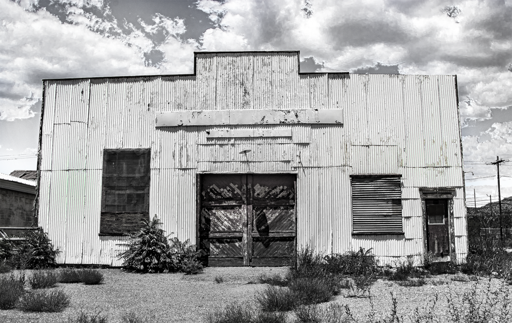 A black and white photograph of an abandoned building.
