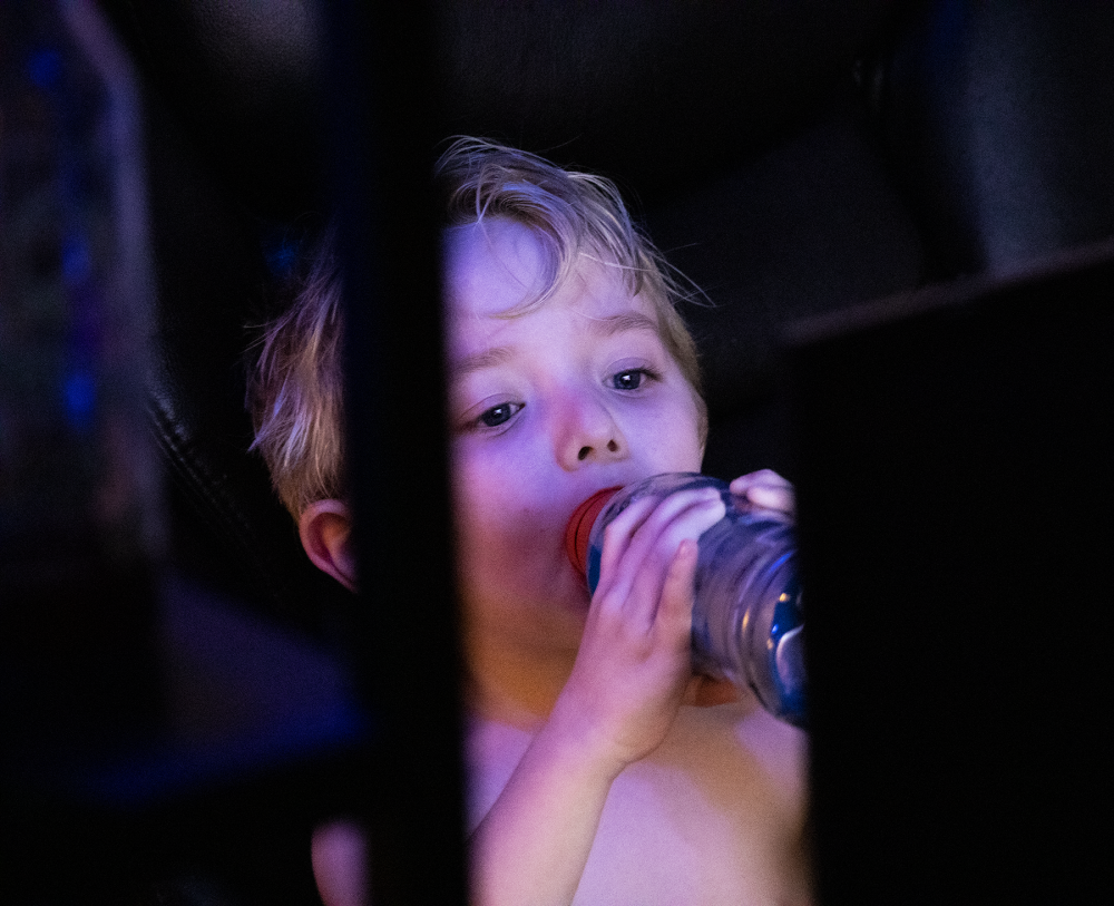 Digital photograph of a boy drinking.