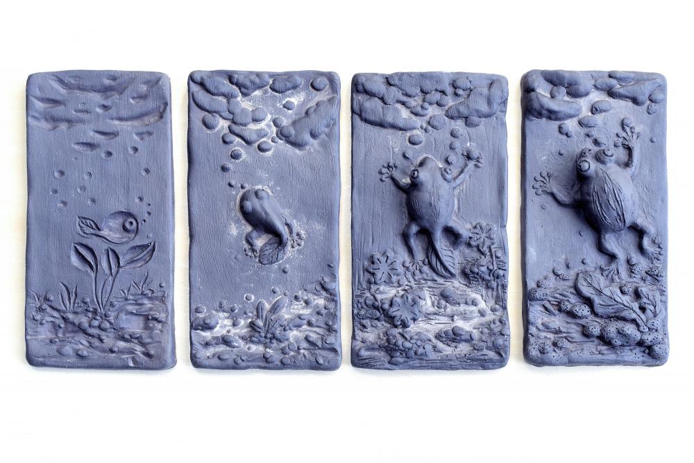 Four panel ceramic tile with the lifecycle of a frog.