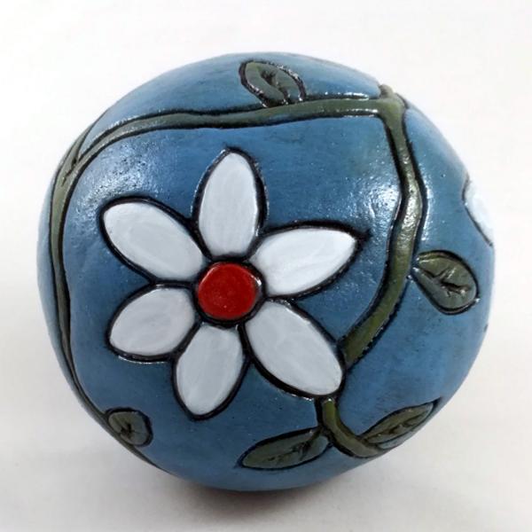 Blue ceramic ball with flowers.
