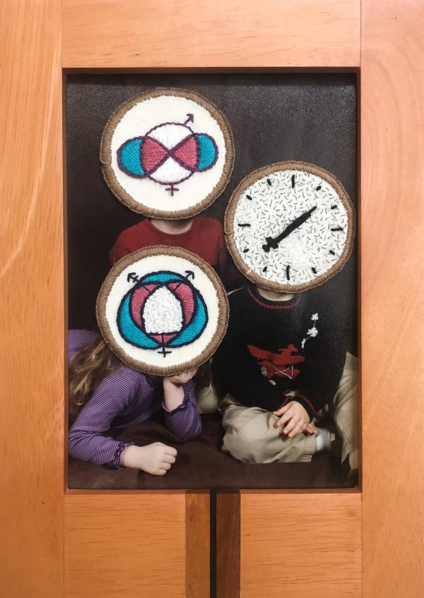 Photograph of a family with embroidery patches over their faces.