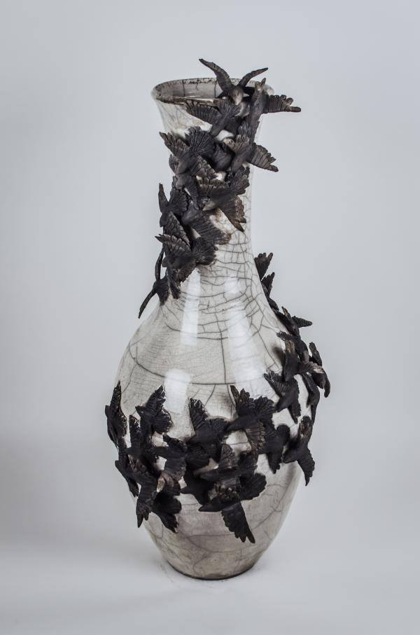 White ceramic vase with black crows wrapped around.