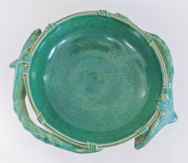 Teal ceramic bowl with sharks on the rim of the bowl.