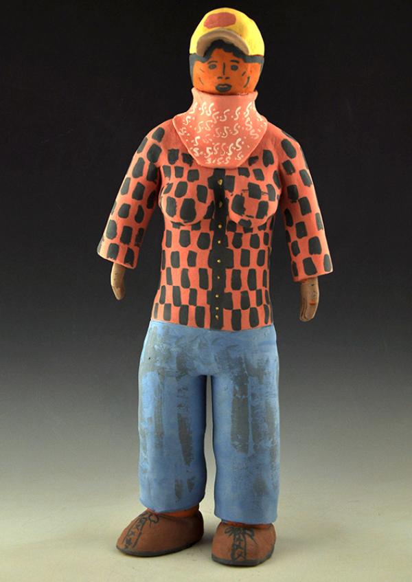 Ceramic figure standing in plain clothes. 