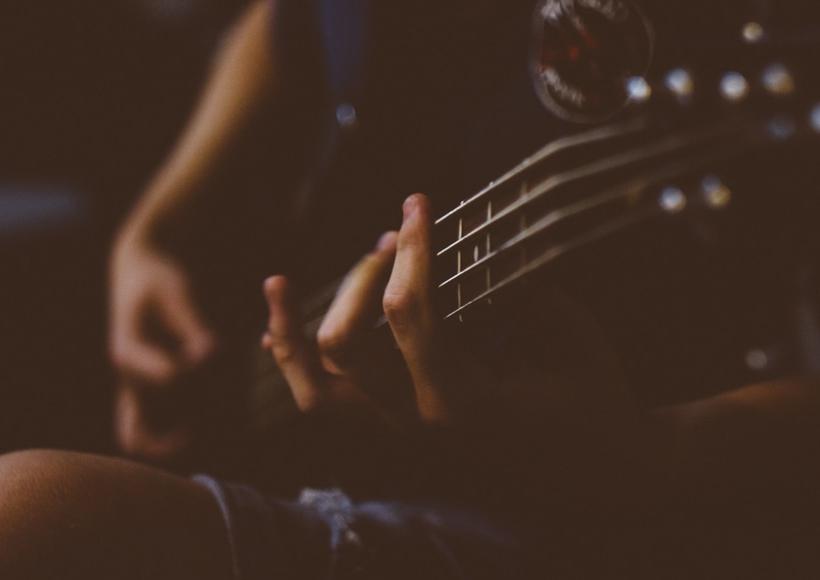 Close up hands on a guitar