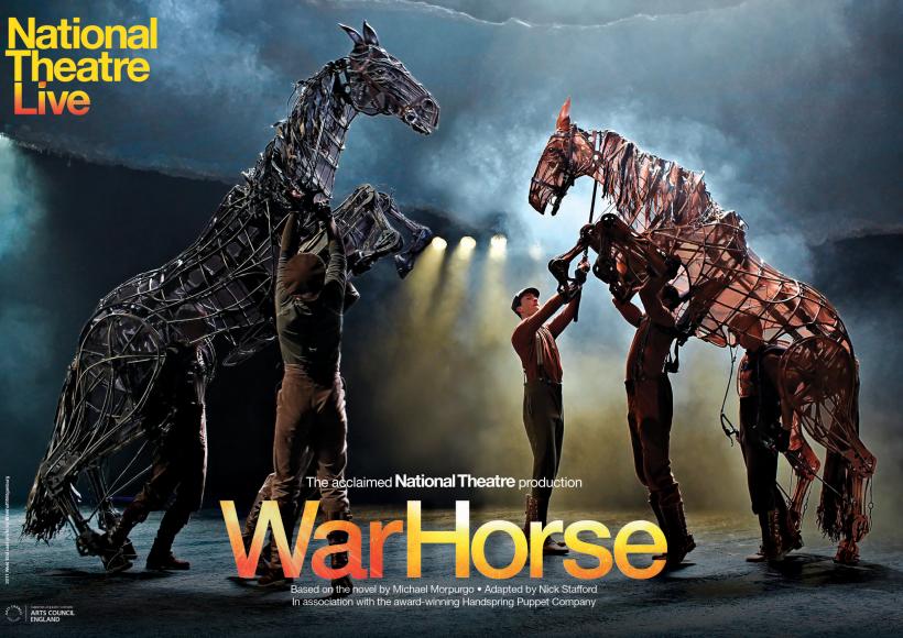 Two life sized war horse puppets on stage with five puppeteer operators on stage