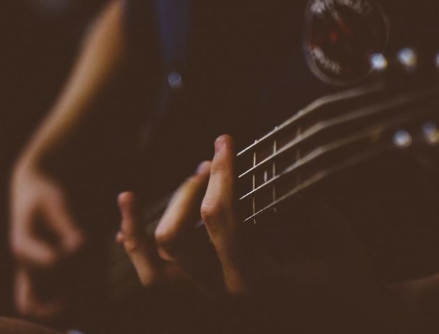Close up hands on a guitar